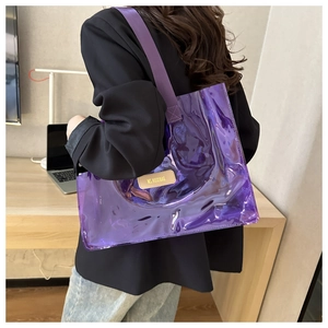 Detail of laser iridescent purple transparent PVC tote bag shown worn on the shoulder