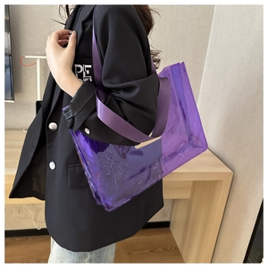 Detail of purple transparent PVC cosmetic tote bag with stylish wide woven strap