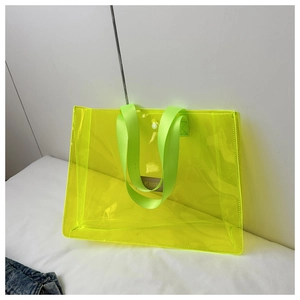 Close-up of waterproof transparent PVC tote bag with neon green reinforced nylon handles