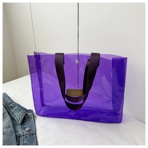 Detail view of purple transparent PVC tote bag with stylish strap and metal snap button