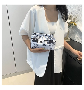 Detail shot of white nylon cloud clutch bag with Chinese ink landscape painting pattern