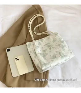 White woven tote bag size comparison with phone and iPad featuring butterfly print