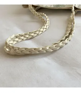 Detailed macro view of the cream woven leather strap on a large shoulder tote bag