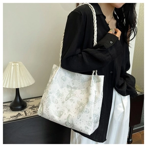 Detail of white butterfly print tote bag with woven rope handles and large capacity