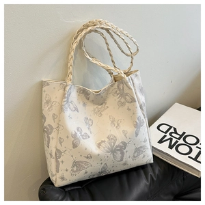 Detail of woven straps and butterfly print on large capacity tote bag for daily use