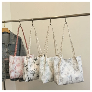 Multiple butterfly print tote bags in pink black green and silver with woven straps