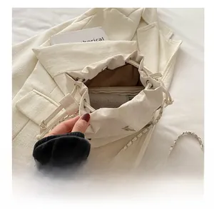 Interior view of white drawstring bucket bag showing storage capacity for daily essentials