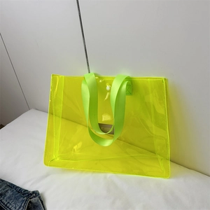 Large fluorescent yellow transparent PVC tote bag with wide strap handles and snap button