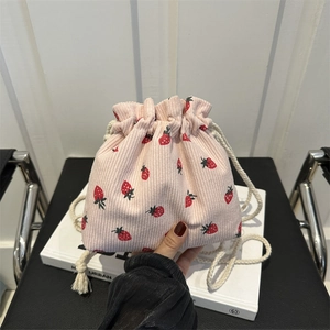Pink corduroy bucket bag with strawberry floral pattern and white drawstring closure