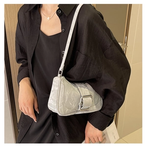 Detail of silver metallic shoulder bag with pleated texture and square metal buckle