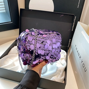 Sparkly purple sequin crossbody bag with silver metal chain in a gift box packaging
