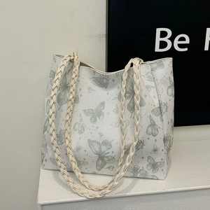 Large butterfly print tote bag with woven shoulder straps and textured leather finish