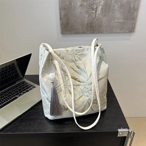 Beige Chinese style tote bag with bamboo embroidery and elegant pearl tassel detail