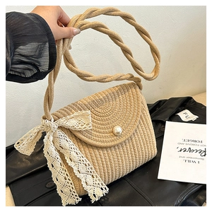 Close-up of woven straw bag featuring delicate lace bow and elegant pearl button closure