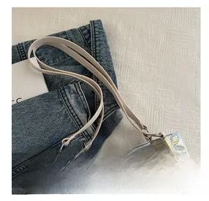 Close-up of comfortable cream faux leather handle on butterfly jacquard bucket bag