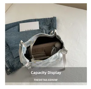Detail showing high-capacity white tote interior with blue butterfly pattern and daily items