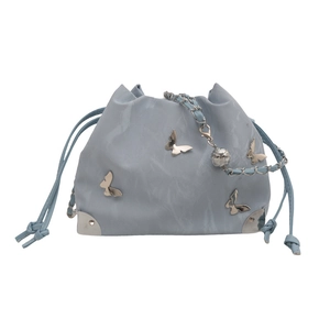 Light blue butterfly drawstring bucket bag with silver metal corners and chain strap