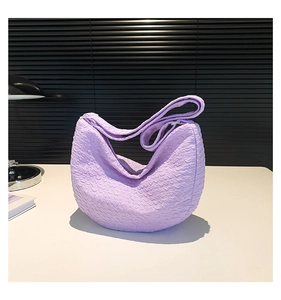 Detail of light purple crescent shoulder bag featuring unique popcorn bubble texture