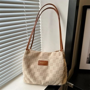 Minimalist beige checkered tote bag with brown leather accents and long handles