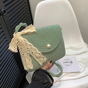 Green woven lace crossbody bag with pearl clasp and large bow for elegant summer style