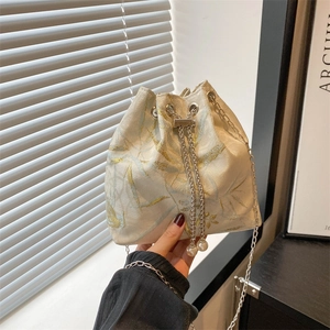 Elegant floral jacquard drawstring bucket bag with silver chain strap and pearl accents