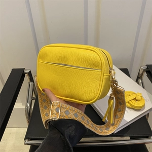 Yellow lychee texture square bag with ethnic woven wide strap and tassel charm