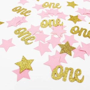 Détail de confettis étoiles rose et doré pailleté avec texte 'one' pour premier anniversaire