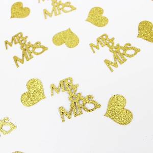 Close-up of gold glitter Mr & Mrs and heart confetti for wedding party decorations