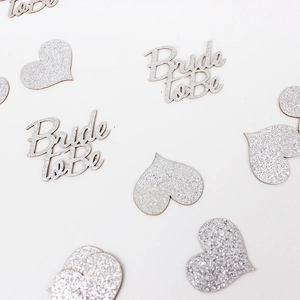 Close-up of silver glitter Bride to Be and heart confetti for wedding party table decor