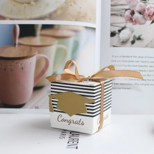 Elegant graduation favor gift box with gold ribbon and mortarboard cap cutout