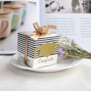 Square graduation gift box with black stripes, golden mortarboard and satin ribbon