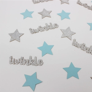 Detail of blue stars and silver glitter twinkle confetti for baby shower table decor