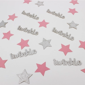 Close-up of pink and silver glitter star confetti with twinkle letter cutouts for parties