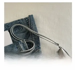 Detailed top view of silver crocodile pattern tote bag with slim handles and metallic finish