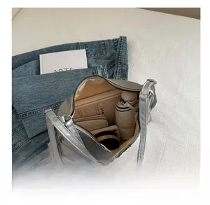 Silver eel-textured shoulder bag showing large interior capacity for daily essentials