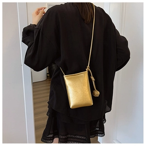 Detail of golden mini crossbody phone bag with pleated texture and decorative rope knot