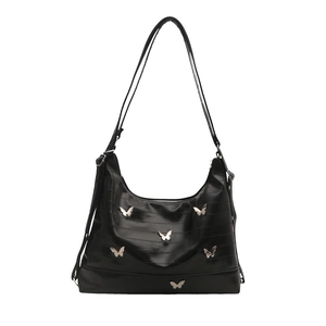 Chic black shiny leather hobo bag with silver butterfly charms and adjustable shoulder strap