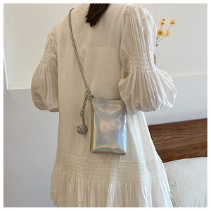 Holographic crossbody phone bag with braided knot detail shown on a model