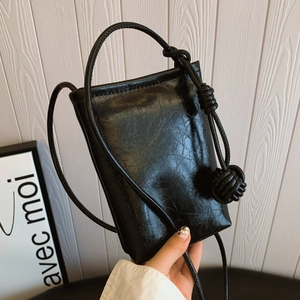 Minimalist black mini crossbody phone bag with vintage crinkle texture and knot strap