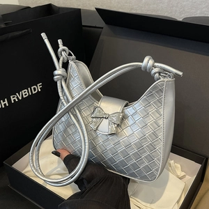 Silver woven hobo bag with a metallic knot handle and a silver bow clasp detail