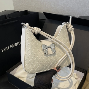 Woven white underarm bag with silver butterfly buckle and knotted shoulder strap