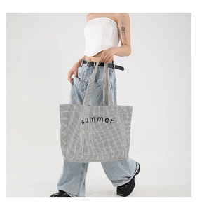 Close-up of black and white striped canvas tote bag featuring summer text print