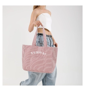 Detail of red and white striped canvas tote bag with Summer embroidery on the front