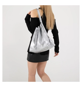Close-up of metallic silver PU tote bag showing square quilted texture and drawstring detail