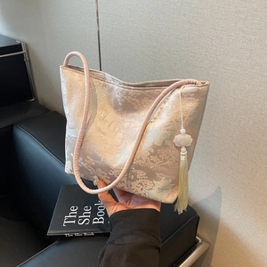 Elegant champagne jacquard tote bag with mountain embroidery and a lotus tassel pendant