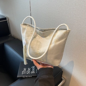Elegant Chinese style beige jacquard bucket bag with floral embroidery and silk tassel