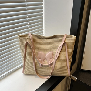 Large straw tote bag with pink bow and leather straps for summer beach or commute