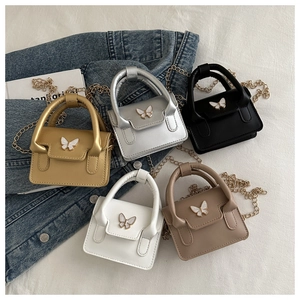 Miniature crossbody bags in five metallic colors featuring pearl butterfly buckles and chains
