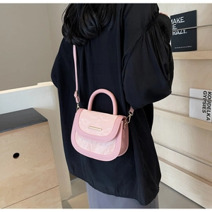 Close-up of pink saddle bag featuring marble texture flap and gold hardware detail