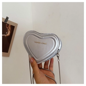 Close-up of heart-shaped silver metallic leather crossbody bag with chain strap